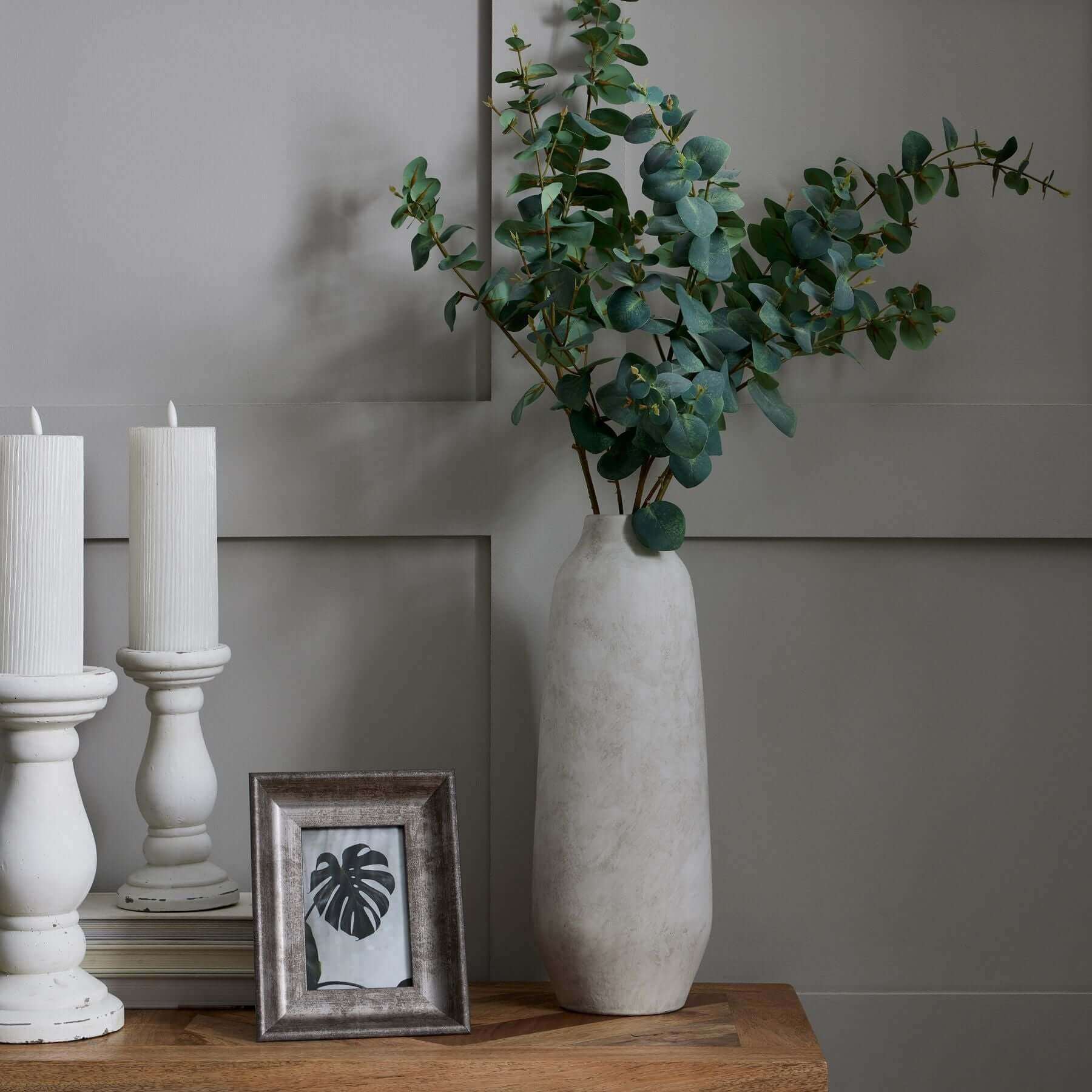 Darcy Tall Ople Vase | Description The Darcy Ople Vase boasts a modern shape and classic color, making it a perfect fit for both minimalist and country chic homes. Its natural stone finish adds texture, while the slim neck allows for a stylish display of