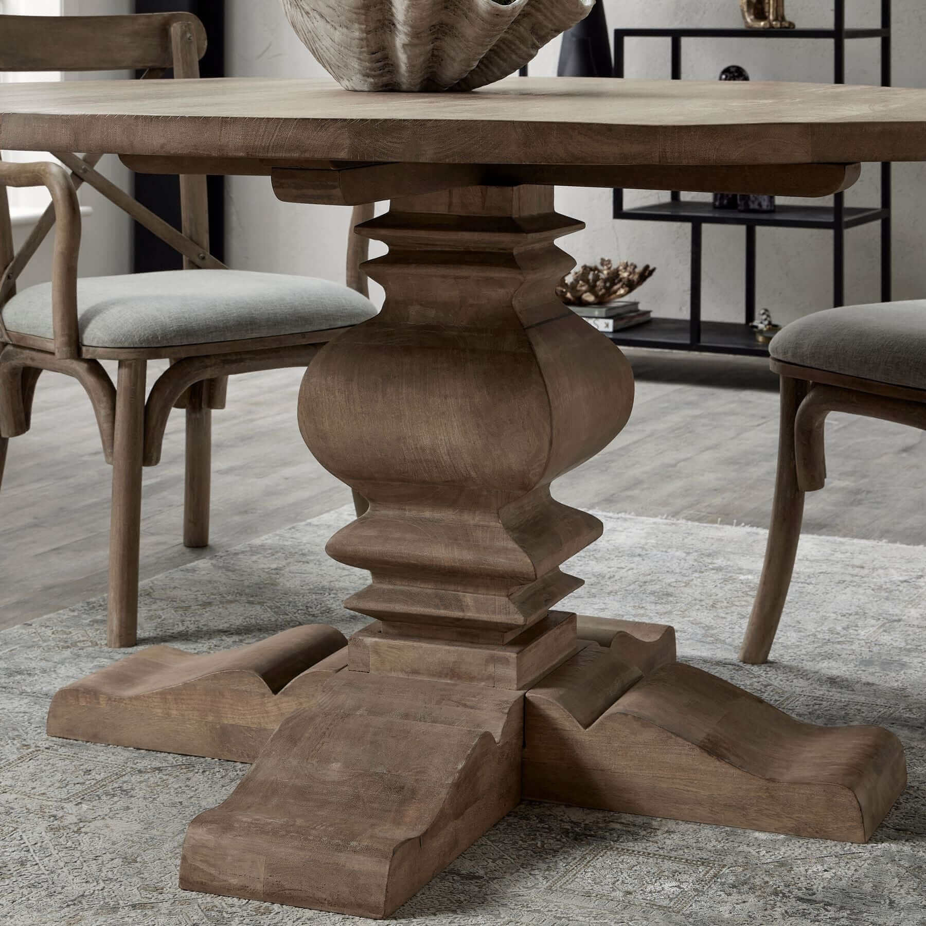 Copgrove Pedestal Dining Table | Description Enter the perfect setting for memorable gatherings for 4-6 guests with the Copgrove Pedestal Dining Table. This French-style round table is hand-crafted from hardwood and finished with a washed bleach look to c