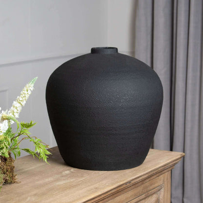 Matt Black Astral Vase | Description Elevate your home decor with the sleek and sophisticated Matt Black Astral Vase. With its large size and slim-neck design, it's perfect for both floor-standing or styled with a smaller vase for a modern, staggered disp