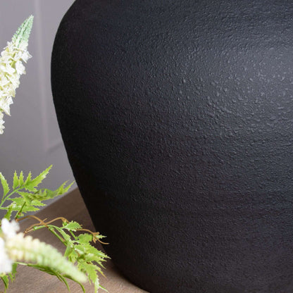 Matt Black Astral Vase | Description Elevate your home decor with the sleek and sophisticated Matt Black Astral Vase. With its large size and slim-neck design, it's perfect for both floor-standing or styled with a smaller vase for a modern, staggered disp