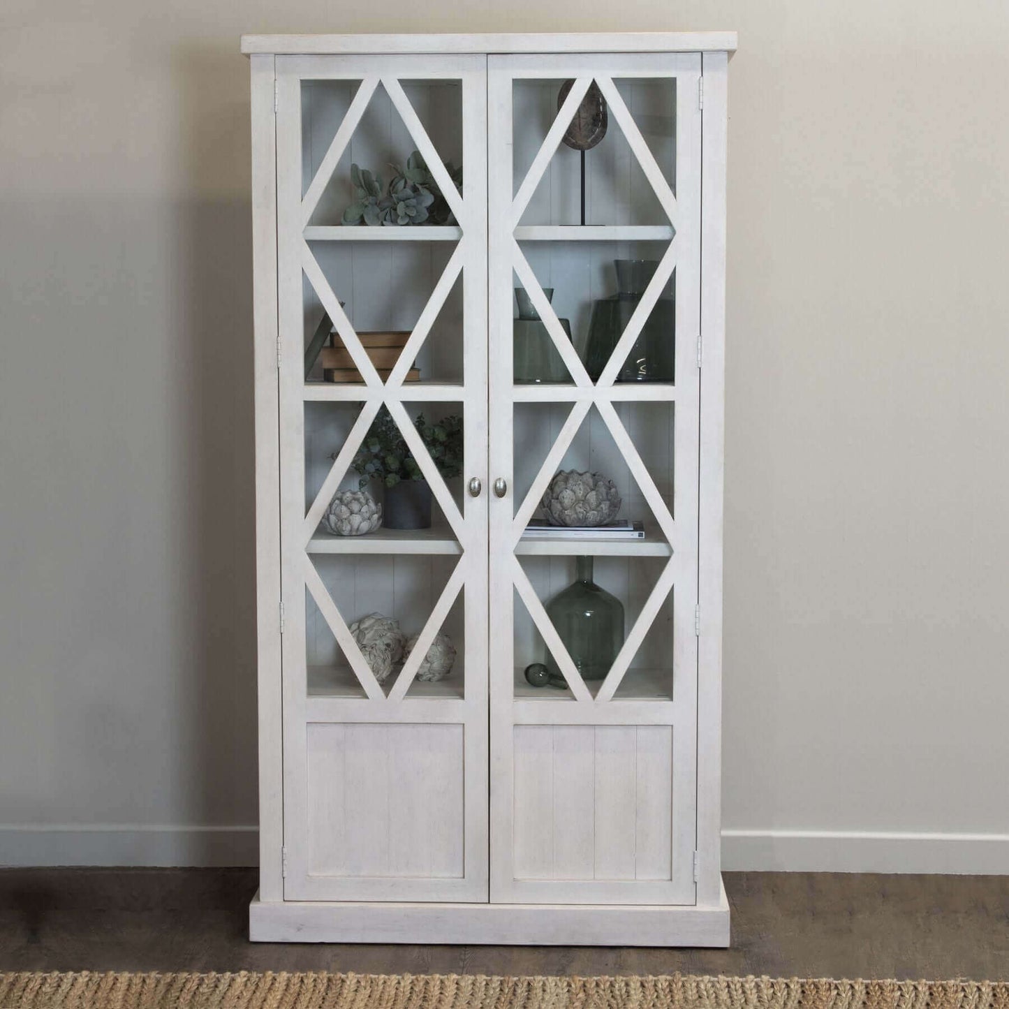 Stamford Cabinet | Description Experience the effortless charm and timeless design of Stamford Cabinet. Its airy, lattice patterned, tempered glass doors add a touch of relaxed elegance to any space. This handmade, planked pine cabinet boasts a familiar,