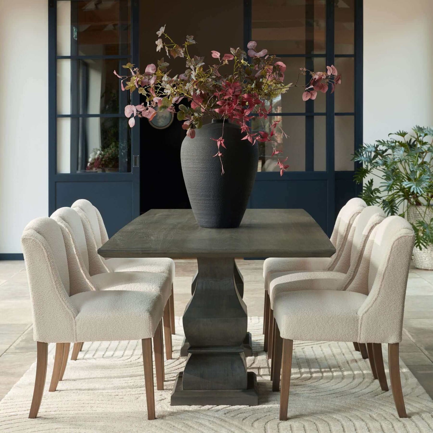 Compton Boucle Dining Chair | Description Introducing the Compton Boucle Dining Chair - a perfect blend of style and functionality. Crafted with a sturdy rubberwood frame, it offers strength and durability for everyday use. The cream boucle upholstery and