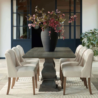 Compton Boucle Dining Chair | Description Introducing the Compton Boucle Dining Chair - a perfect blend of style and functionality. Crafted with a sturdy rubberwood frame, it offers strength and durability for everyday use. The cream boucle upholstery and