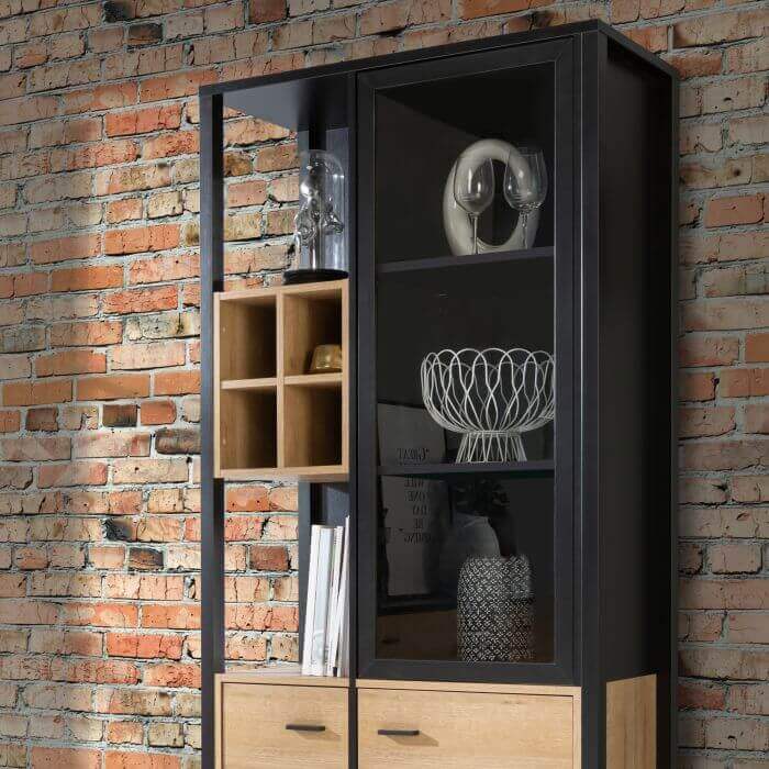 High Rock Display Cabinet | Description High Rock features a captivating and contemporary design, combining Riviera Oak decor with deep black accents to create a unique and eye-catching piece. In addition to its stunning appearance, High Rock is also high