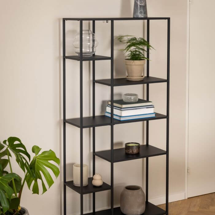 Sleek Newcastle Wall Unit with asymmetrical shelves, stylishly displaying books and decor items in a modern home setting