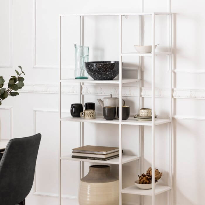 Sleek white Newcastle Wall Unit with asymmetrical shelves and modern décor items in a minimalist home setting