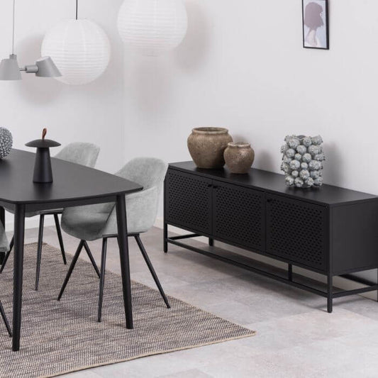 Newcastle 3 Door Sideboard in a modern dining room with black table and grey chairs, showcasing industrial chic design and functionality.