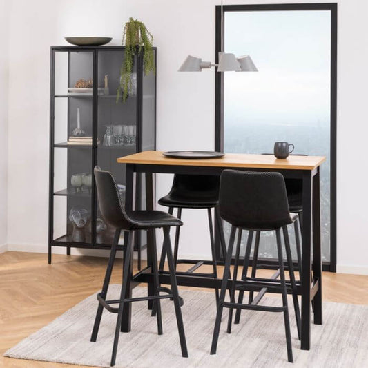 Modern dining area with Newcastle 2 Door Display Cabinet in black powder-coated steel and tempered glass, showcasing collectibles and tableware.